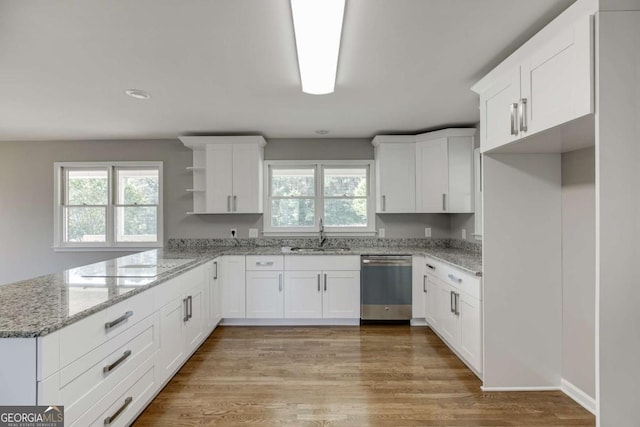 kitchen featuring dishwasher, light wood-style flooring, a peninsula, open shelves, and a sink