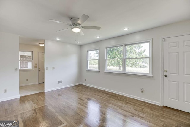 spare room featuring baseboards, visible vents, wood finished floors, and recessed lighting