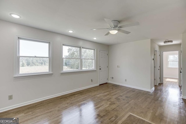 empty room featuring visible vents, baseboards, ceiling fan, wood finished floors, and recessed lighting