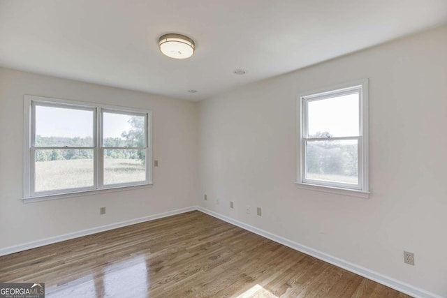 empty room featuring baseboards and wood finished floors