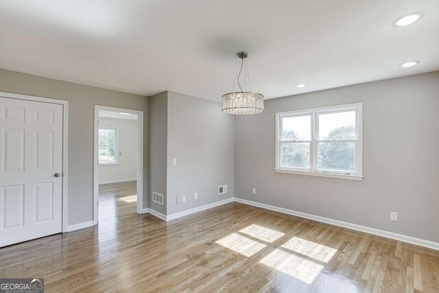 interior space with recessed lighting, wood finished floors, visible vents, and baseboards