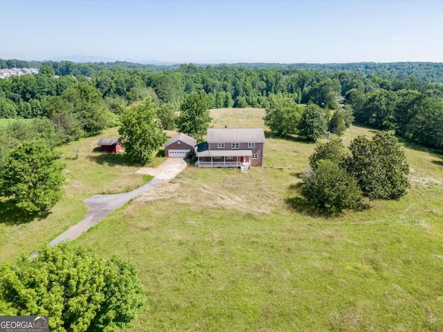 birds eye view of property with a rural view and a wooded view