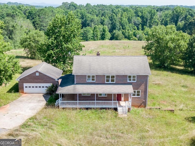 birds eye view of property with a wooded view