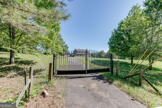 view of gate with fence