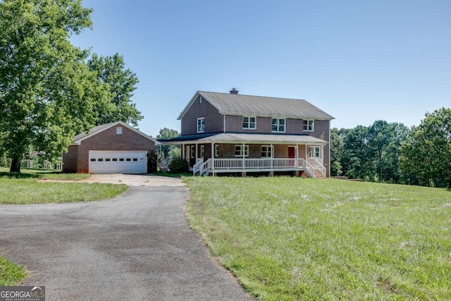 view of front of property with covered porch, a garage, an outdoor structure, a front lawn, and a chimney