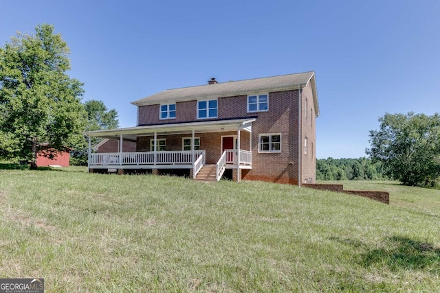 view of front of house with covered porch, brick siding, and a front lawn