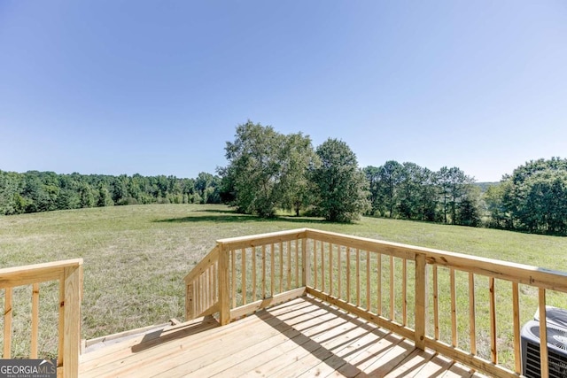 wooden deck with a lawn and a rural view