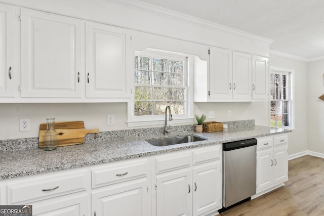 kitchen featuring light wood-style flooring, a sink, white cabinets, stainless steel dishwasher, and crown molding