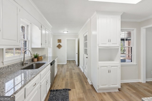 kitchen with ornamental molding, white cabinetry, a sink, and dishwasher