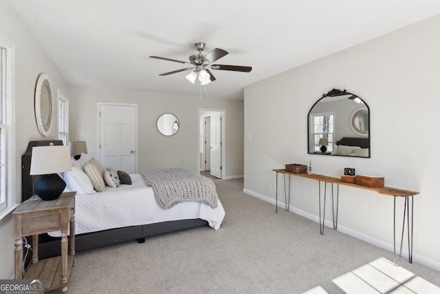 bedroom with ceiling fan, carpet, and baseboards