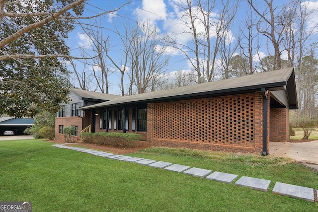 view of home's exterior featuring a yard and brick siding