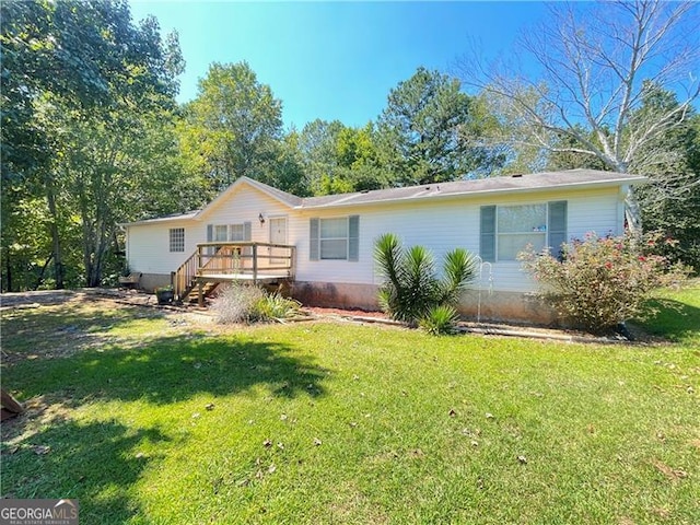 view of front of property featuring a front yard and a wooden deck