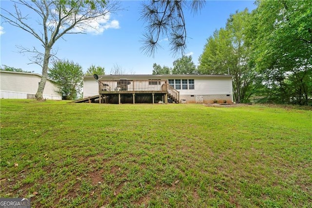 rear view of property featuring crawl space, a lawn, and a wooden deck