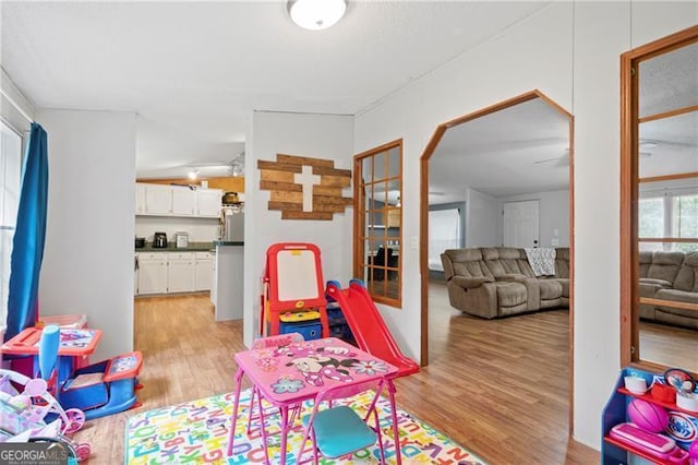 game room with light wood-type flooring and french doors