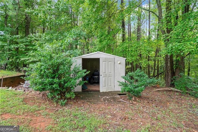 view of shed featuring a forest view