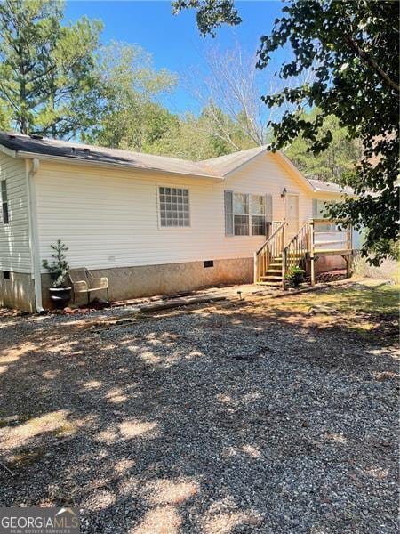 rear view of property featuring crawl space