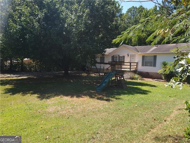 view of jungle gym featuring a lawn