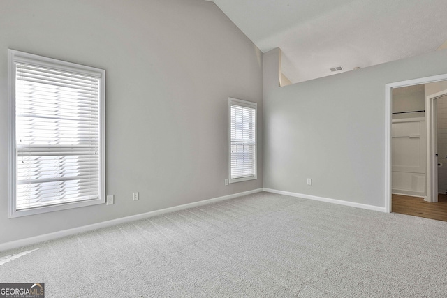 unfurnished bedroom with carpet floors, baseboards, multiple windows, and visible vents