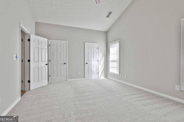 unfurnished bedroom featuring carpet floors, baseboards, visible vents, and a textured ceiling