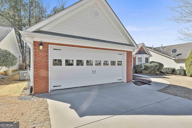 garage with driveway and central AC