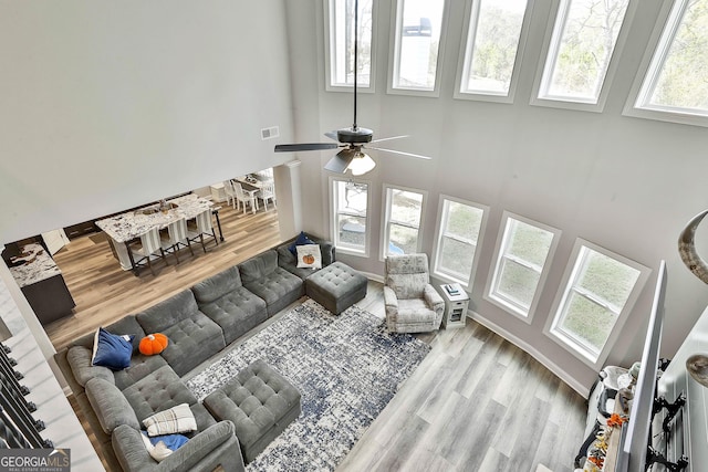 foyer featuring stairway, baseboards, beamed ceiling, and wood finished floors