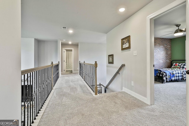 hallway with recessed lighting, carpet floors, visible vents, baseboards, and an upstairs landing