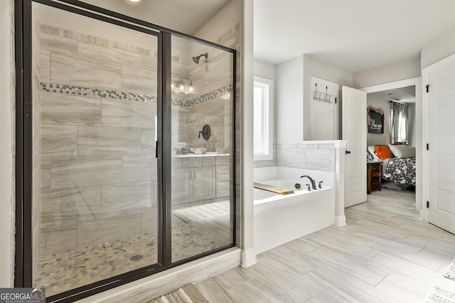 ensuite bathroom featuring a garden tub, ensuite bath, and a shower stall