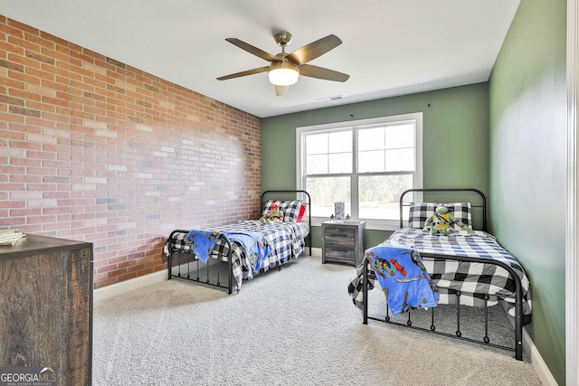 bedroom with ceiling fan, brick wall, visible vents, baseboards, and carpet