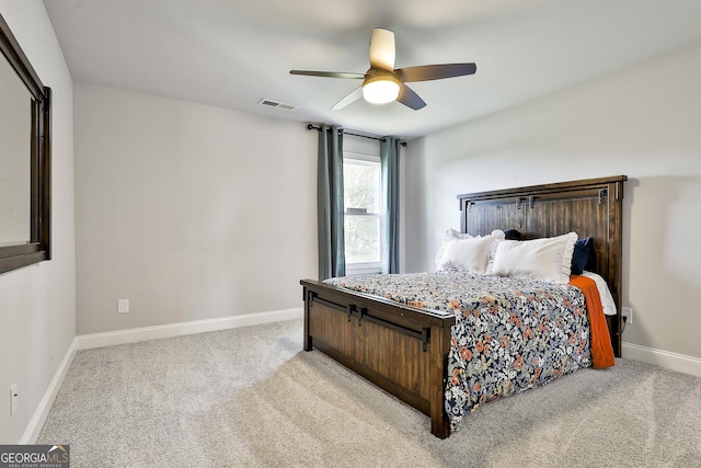 carpeted bedroom with baseboards, visible vents, and ceiling fan