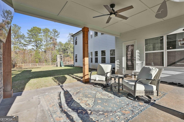 view of patio / terrace featuring outdoor lounge area, a playground, fence, and a ceiling fan