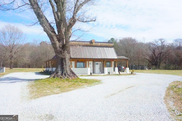 view of front of house with metal roof and driveway