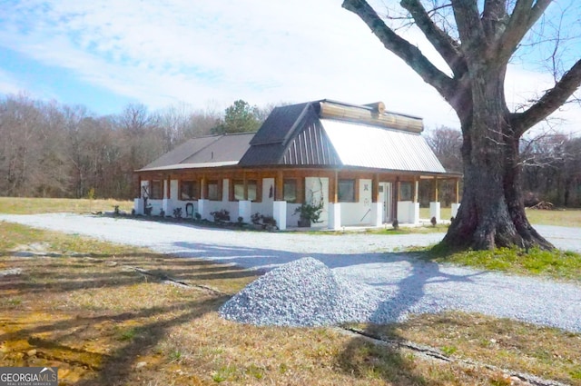 view of side of property featuring metal roof