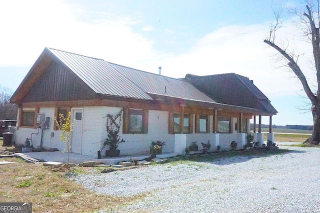 exterior space featuring a standing seam roof and metal roof