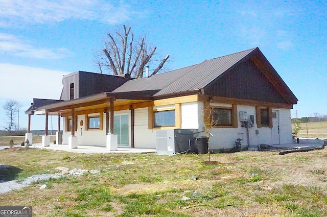 back of property featuring metal roof and central air condition unit