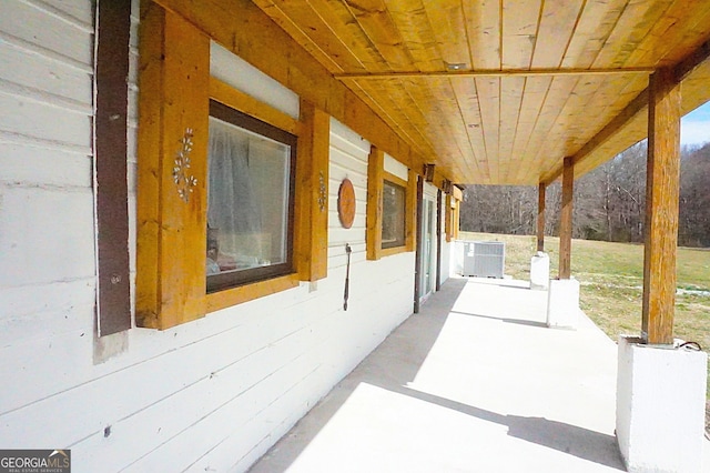 view of patio with central AC unit and a porch