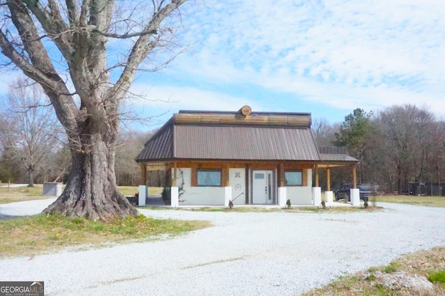 view of front of property with a porch and metal roof