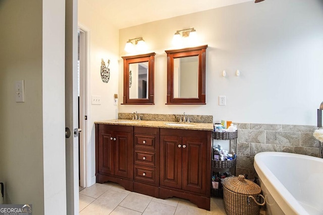 bathroom with double vanity, a soaking tub, tile patterned flooring, and a sink