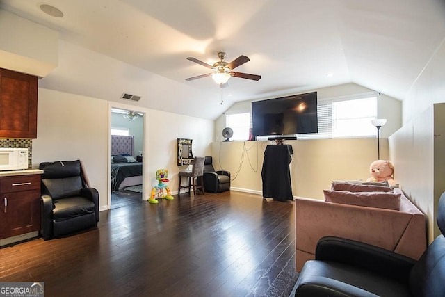 living room featuring visible vents, vaulted ceiling, and dark wood-style flooring