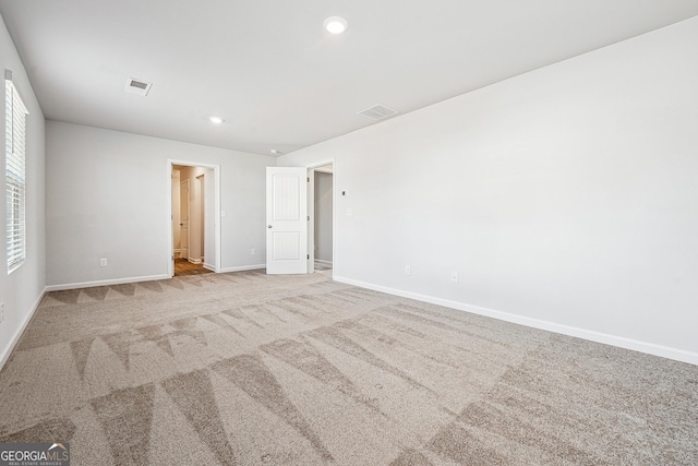 unfurnished bedroom featuring carpet, visible vents, baseboards, and recessed lighting