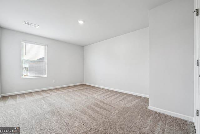 spare room with carpet floors, visible vents, baseboards, and recessed lighting