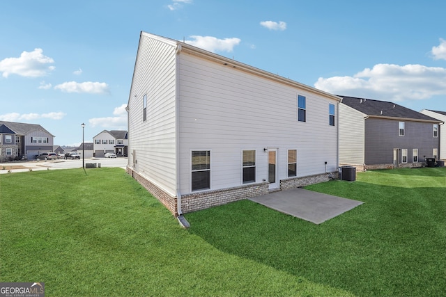 rear view of house featuring brick siding, a patio, central air condition unit, a lawn, and a residential view