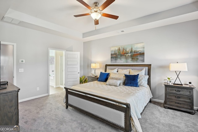 carpeted bedroom featuring a raised ceiling, visible vents, and baseboards