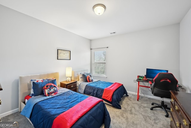 carpeted bedroom featuring baseboards and visible vents