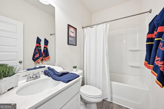 full bathroom with wood finished floors, vanity, toilet, and shower / tub combo