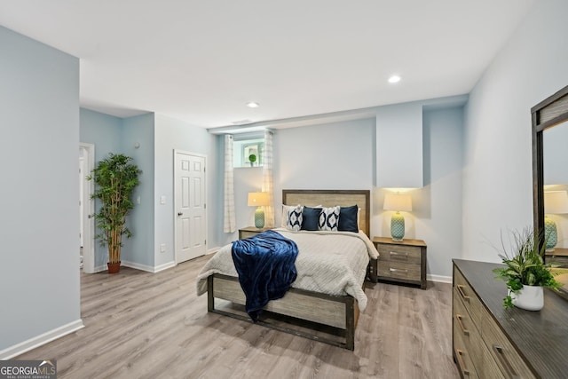 bedroom with recessed lighting, light wood-type flooring, and baseboards