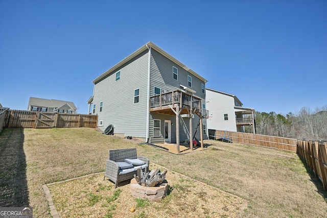 rear view of house featuring a fenced backyard and a yard