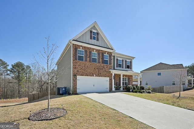 view of front of house with a garage, brick siding, concrete driveway, board and batten siding, and a front yard