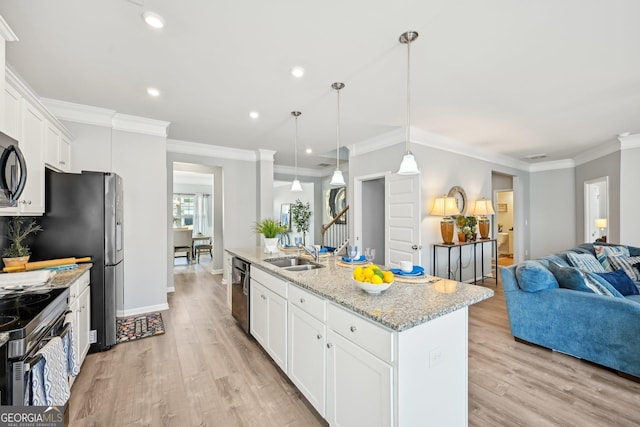 kitchen with open floor plan, black appliances, a sink, and crown molding