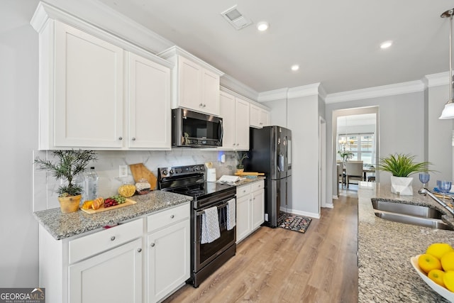 kitchen with stainless steel appliances, visible vents, a sink, and crown molding