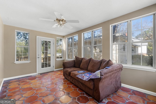 sunroom with a ceiling fan and a healthy amount of sunlight